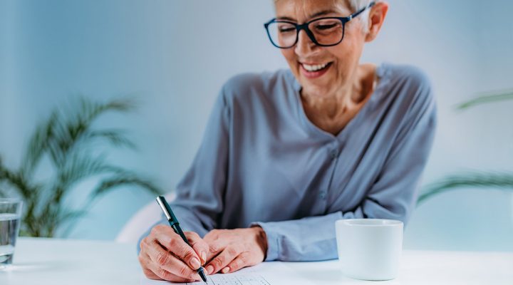 woman doing some notes on a paper