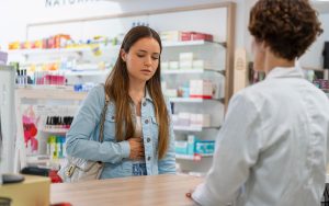 woman with pain at the pharmacy