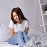 woman in bed with pain