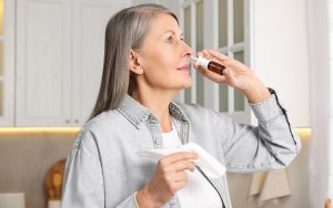 Woman using nasal spray
