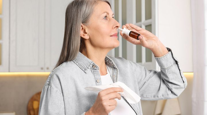 Woman using nasal spray