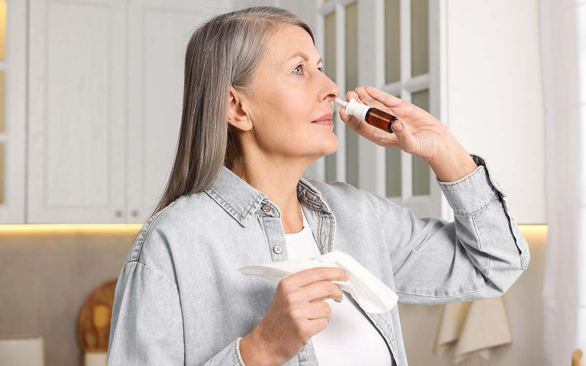 Woman using nasal spray