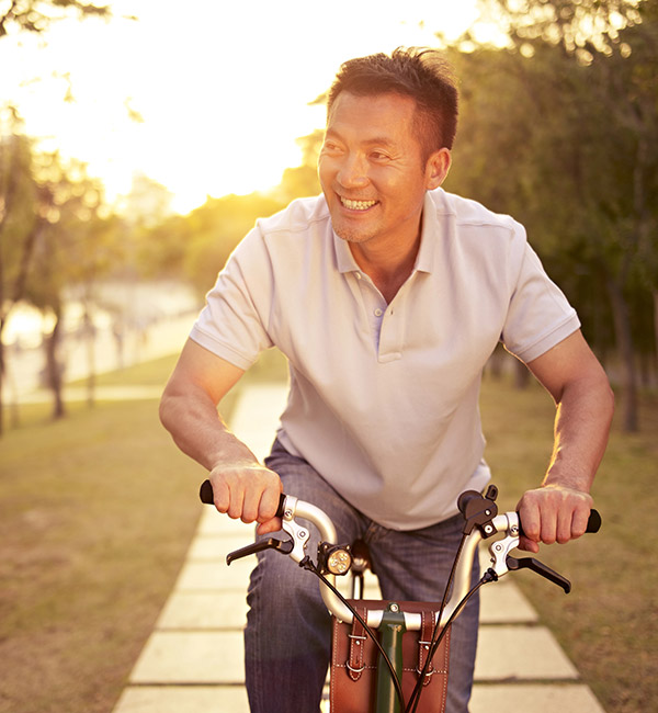 man smiling on his bike