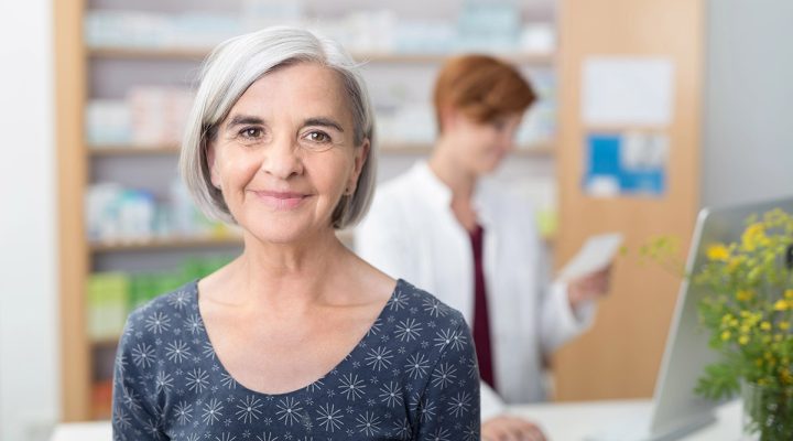 senior woman smiling at a pharmacy