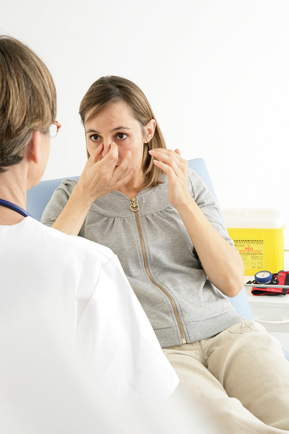 woman sinus infection with doctor