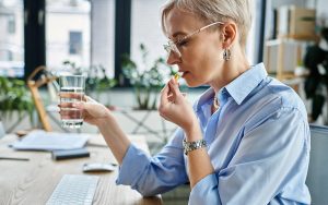 business woman taking her compounded medicine
