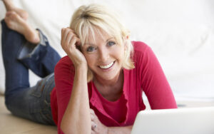 Middle age woman smiling with her laptop