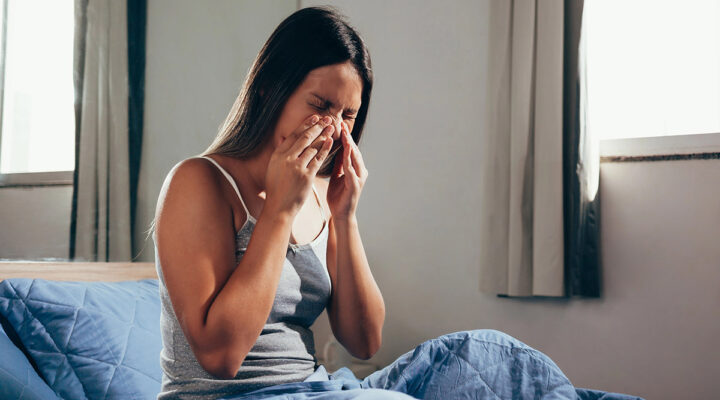 woman holding her nose with Sinus pain