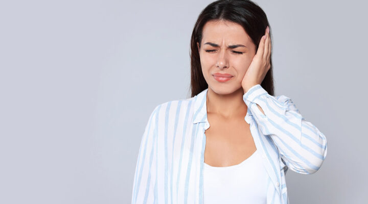 woman with ear infection pain