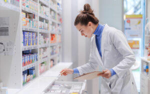 pharmacist checking medicine stock