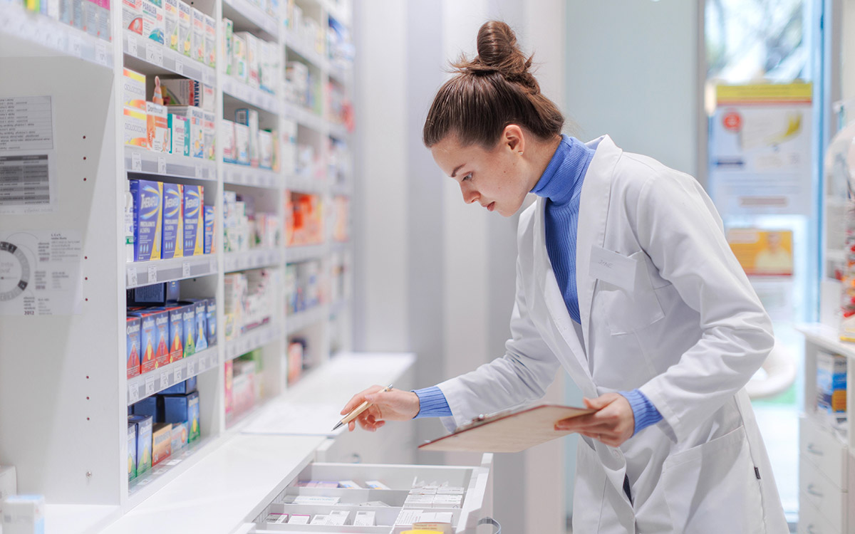 pharmacist checking medicine stock