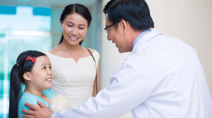 Pediatrician with patient and her mom