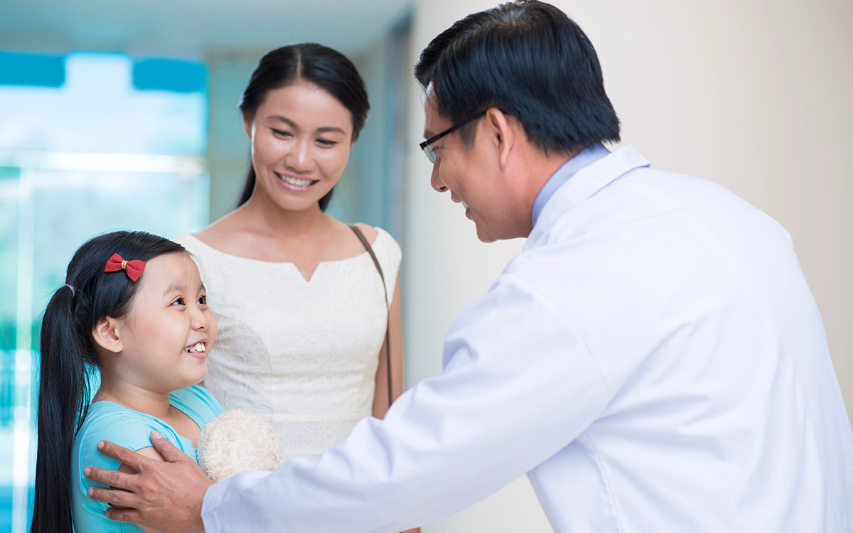 Pediatrician with patient and her mom