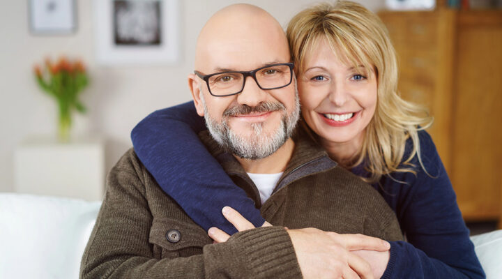 happy healthy couple smiling at home
