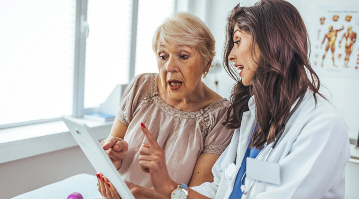 doctor with patient looking at a tablet