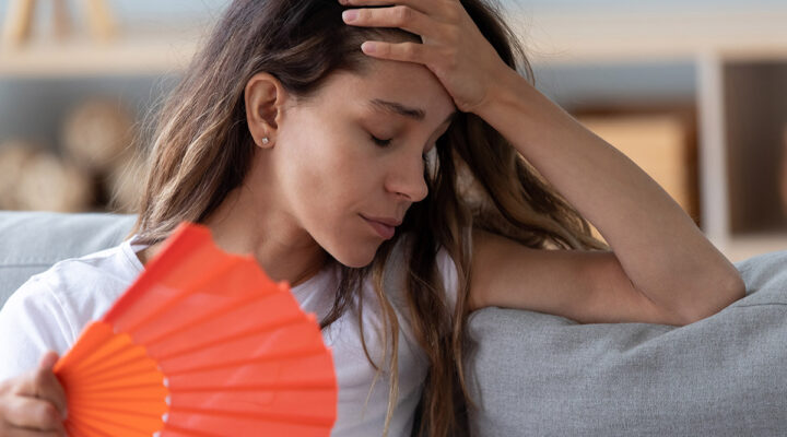 woman at home with a fan