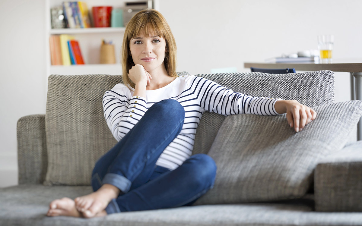 woman sitting at home happy