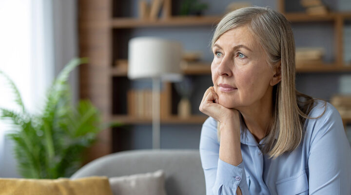 mature woman at home looking at the window