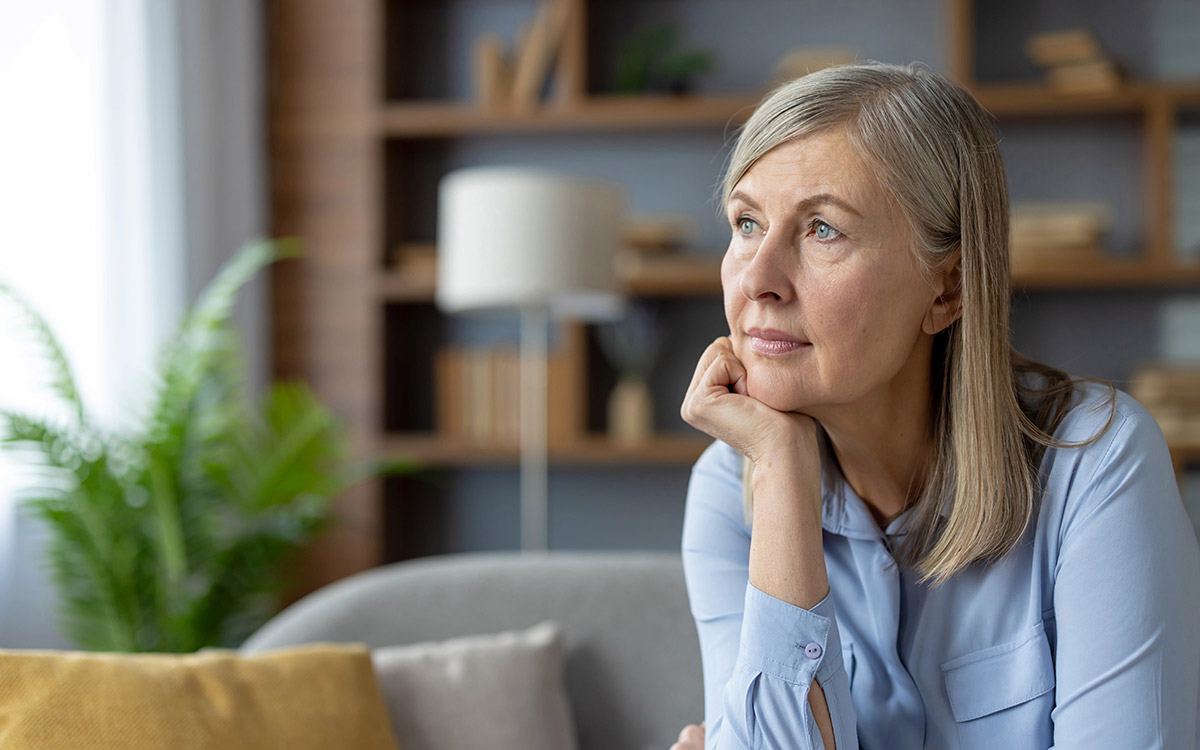 mature woman at home looking at the window