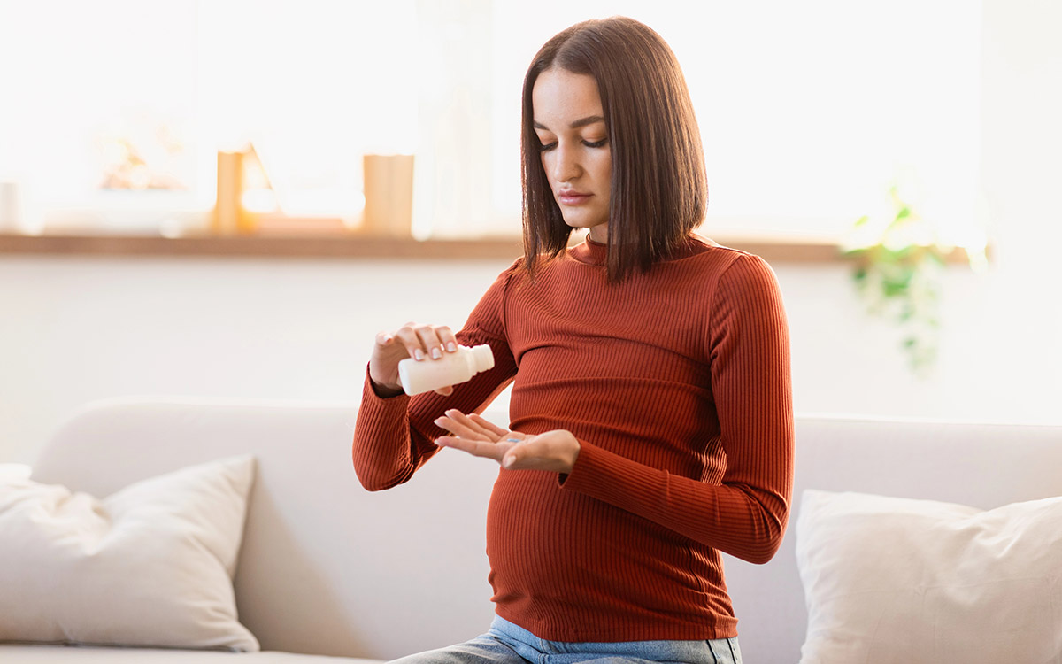 woman at home taking her medicine and vitamins