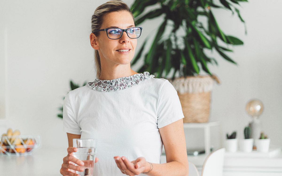 woman taking her compound medicine at home
